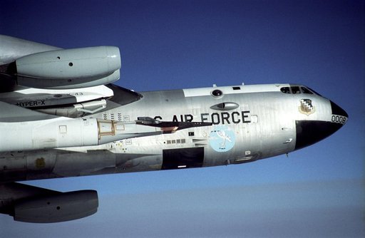 The black X-43A rides on the front of a modified Pegasus booster rocket hung from the special pylon under the wing of NASA's B-52B mother ship. The photo was taken during a captive carry flight Jan. 26, 2004 to verify systems before an upcoming launch