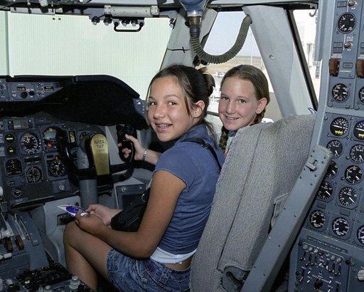 Leah Robson and Bridgette Puljiz in the flight deck of NASA's 747 shuttle carrier during Take Your Children to Work Day