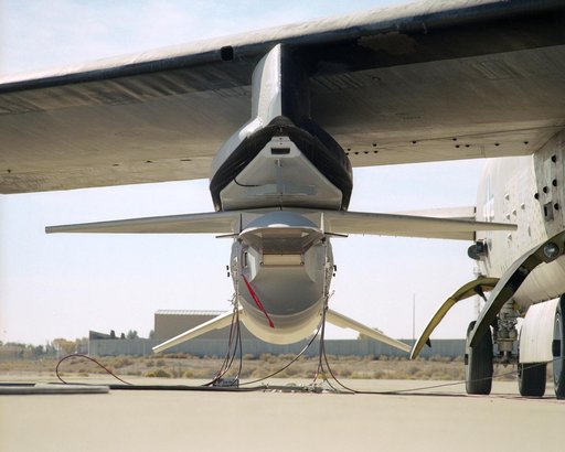 The small size of the X-43A scramjet is evident in this nose-on view while mounted to its modified Pegasus booster under the wing of NASA's B-52B mothership