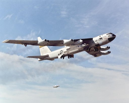 With the X-43A and its booster rocket tucked under its right wing, NASA's venerable B-52B mothership climbs out after takeoff on its final research mission