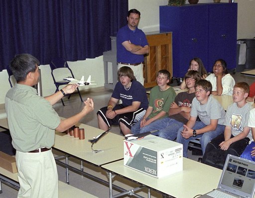 NASA Dryden aerospace engineer Trong Bui explains the dynamics of flight to a group of Edwards Middle School students during a recent Career Day presentation.