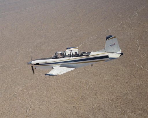 A Beech T-34C flown by NASA Dryden Flight Research Center for mission support descends over the Southern California desert near Edwards Air Force Base
