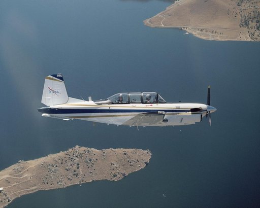 A Beech T-34C aircraft used by NASA Dryden Flight Research Center for mission support banks over Lake Isabella in Kern County during a recent flight
