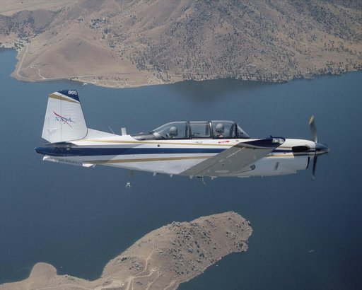 A Beech T-34C aircraft used by NASA Dryden Flight Research Center for mission support banks over Lake Isabella in Kern County during a recent flight
