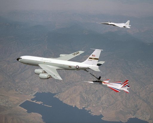 One of NASA's two F-15 research aircraft gets refueled in mid-air over Lake Isabella from a USAF KC-135 tanker while NASA's other F-15 flies chase alongside.