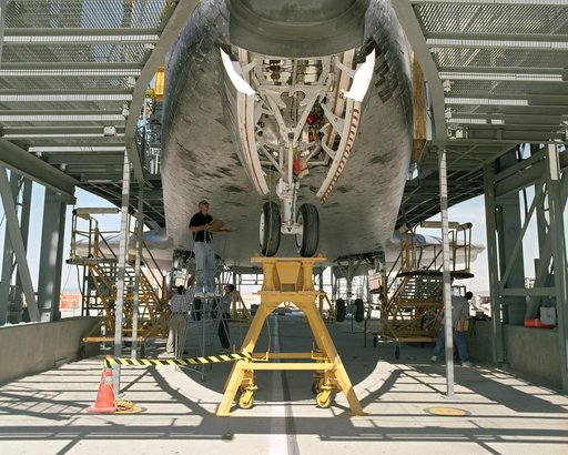 The Space Shuttle Discovery receives post-flight servicing in the Mate-Demate Device (MDD) at NASA's Dryden Flight Research Center, Edwards, California