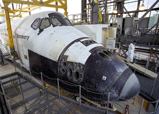 A technician leaves the 'white room,' the access point for entering the Space Shuttle Discovery during post-flight processing at NASA DFRC in California