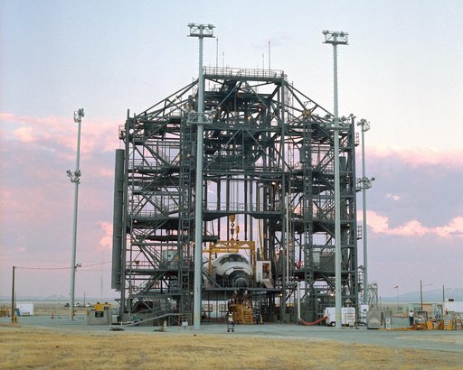 The sun sets on the Space Shuttle Discovery during post-flight processing in the Mate-Demate Device (MDD), following its landing at NASA DFRC in California