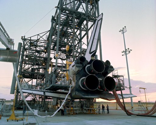 The sun sets on the Space Shuttle Discovery during post-flight processing in the Mate-Demate Device (MDD), following its landing at NASA DFRC in California