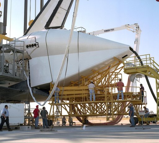 Technicians attach the tail cone to the Space Shuttle Discovery in preparation for its return to NASA's Kennedy Space Center in Florida