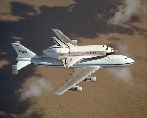The space shuttle Discovery atop NASA's modified 747 is captured over the Mojave Desert while being ferried from NASA Dryden to the Kennedy Space Center