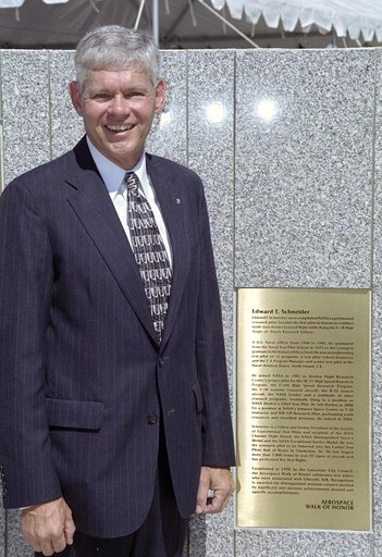 Former NASA research pilot Eddie Schneider with the brass plaque summarizing his career during the 2005 Aerospace Walk of Honor ceremonies in Lancaster, Calif.