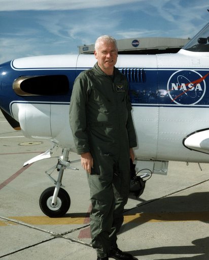 Pilot Ed Lewis with T-34C aircraft on ramp
