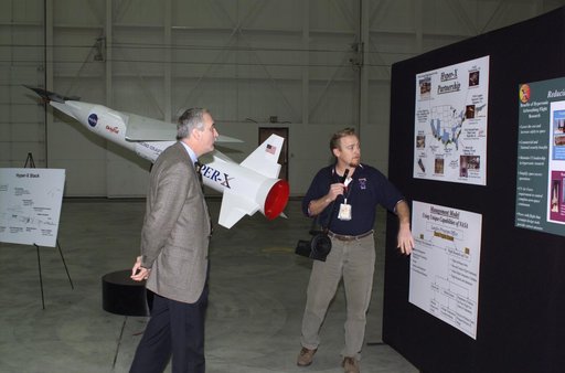NASA Administrator Sean O'Keefe, left, learned about the Mach 10 X-43 research vehicle from manager Joel Sitz during a visit to the NASA Dryden Flight Research Center, Edwards, California, January 31, 2002