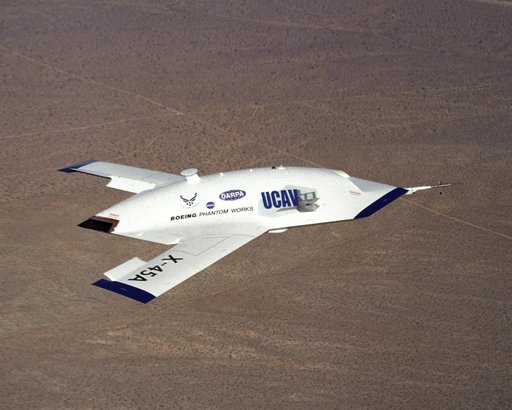X-45A in flight with F-18 #846 chase aircraft, during first GPS-guided weapon demonstration flight