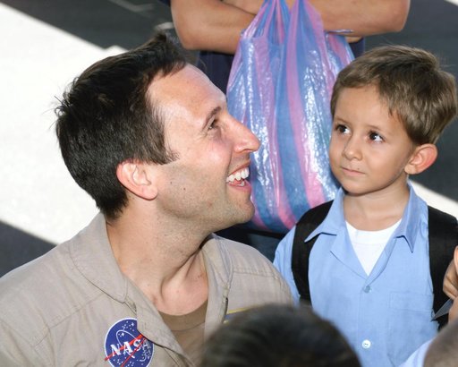 DFRC Mission Manager Walter Klein passes out stickers and lithographs to underprivileged Costa Rican school children that visited the airport on Monday March 8, 2004
