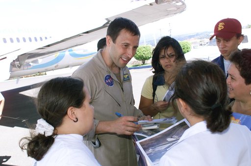 DFRC Mission Manager Walter Klein passes out stickers and lithographs to underprivileged Costa Rican school children that visited the airport on Monday March 8, 2004