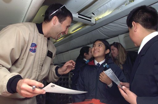 NASA Dryden Mission Manager Walter Klein talks with school children from Punta Arenas, Chile, during a tour of the DC-8 aircraft