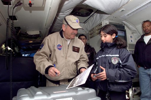 Dr. Tom Mace talks with a student from Punta Arenas, Chile, during a tour of the DC-8 aircraft