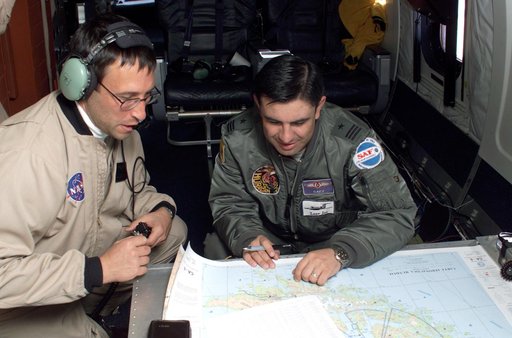 NASA DC-8 Mission Manager Walter Klein and Chilean Air Force Advisor Captain Saez review maps of the Antarctic Peninsula during an AirSAR 2004 mission