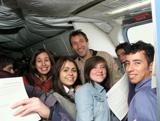 NASA DC-8 Mission Manager Walter Klein poses with a group of Chilean Students onboard the aircraft in Punta Arenas, Chile