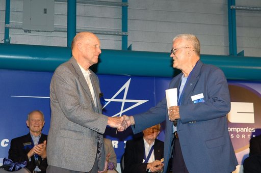 Research pilot and former astronaut Gordon Fullerton is congratulated by retired astronaut Fred Haise upon Fullerton's induction into the Astronaut Hall of Fame