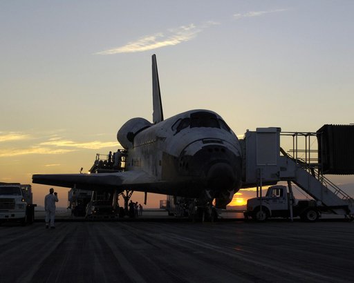 The sun rises on the Space Shuttle Discovery as it rests on the runway at Edwards Air Force Base, California, after a safe landing August 9, 2005