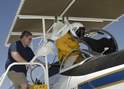 NASA Dryden life support technician Jim Sokolik assists pressure-suited pilot Dee Porter into the cockpit of NASA's ER-2 Earth resources aircraft.