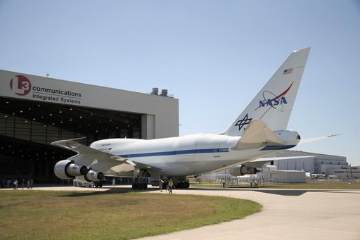 NASA's newly painted Stratospheric Observatory for Infrared Astronomy 747SP is pushed back from L-3 Communications' Integrated Systems hangar in Waco, Texas