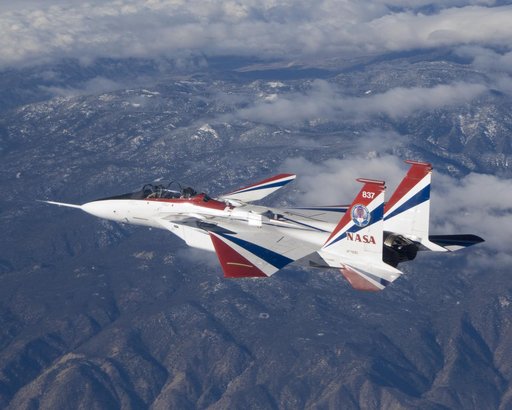 The jagged ridges of Southern California's Tehachapi Mountains form the backdrop to NASA's brightly-colored NF-15B testbed aircraft during a research mission.