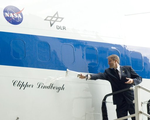 Erik Lindbergh christens NASA's 747 Clipper Lindbergh with a special commemorative concoction representing local, NASA, and industry partners