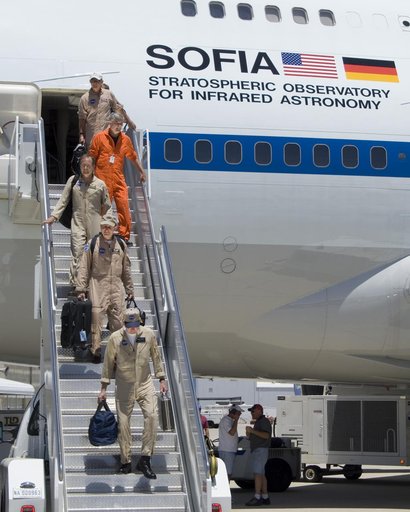 The SOFIA flight crew descends the stairs after ferrying the 747SP airborne observatory from Waco, TX, to NASA's Dryden Flight Research Center in California