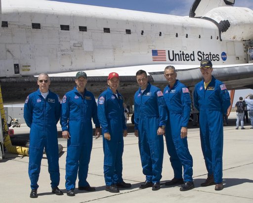 The crew of Space Shuttle mission STS-117 gathered in front of the shuttle Atlantis following landing at Edwards Air Force Base, California, June 22, 2007