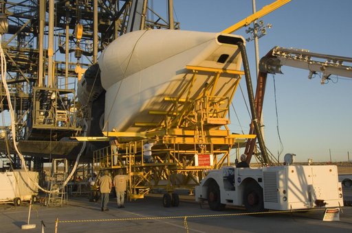 Technicians attach the tail cone to the Space Shuttle Atlantis in preparation for its return to NASA's Kennedy Space Center in Florida