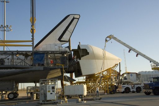 Technicians attach the tail cone to the Space Shuttle Atlantis in preparation for its return to NASA's Kennedy Space Center in Florida