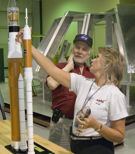 Apollo 11 astronaut Buzz Aldrin and tour guide Mary Ann Harness check out models of the Ares 1 and Ares 5 space vehicles during Aldrin's tour of NASA Dryden