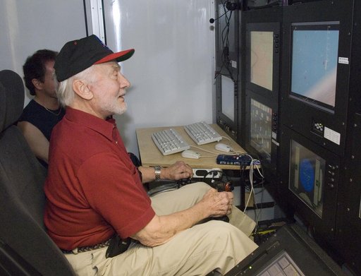 Apollo 11 astronaut Buzz Aldrin tries out the control station for the X-48B Blended Wing Body unmanned subscale demonstrator during a tour of NASA Dryden