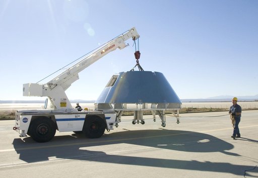 Rogers Dry Lake served as a backdrop for a mockup Orion crew module built by NASA Dryden's Fabrication Branch as it was relocated to Dryden's Shuttle hangar.