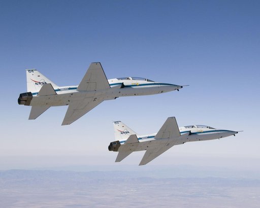 NASA Dryden's two T-38A mission support aircraft fly in tight formation while conducting a pitot-static airspeed calibration check near Edwards Air Force Base