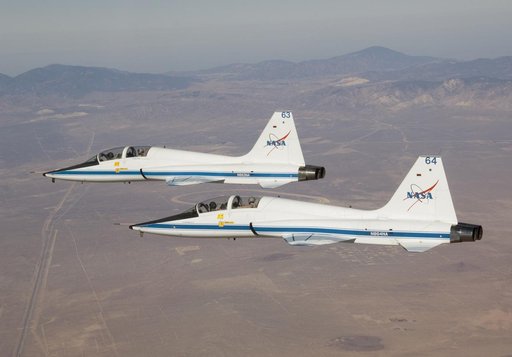NASA Dryden's two T-38A mission support aircraft fly in tight formation while conducting a pitot-static airspeed calibration check near Edwards Air Force Base