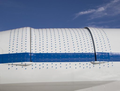Tiny two-inch string tufts blanket the telescope cavity door and related fairings to aid visual monitoring of airflow patterns during SOFIA 747SP flight tests