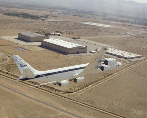 NASA's DC-8 airborne science laboratory banks low over the Dryden Aircraft Operations Facility at Air Force Plant 42 in Palmdale, Calif., upon arrival November 8