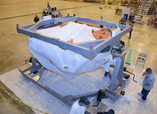SOFIA's primary mirror assembly is cradled on its dolly as technicians prepare to move it into a "clean room" at NASA Dryden's Aircraft Operations Facility