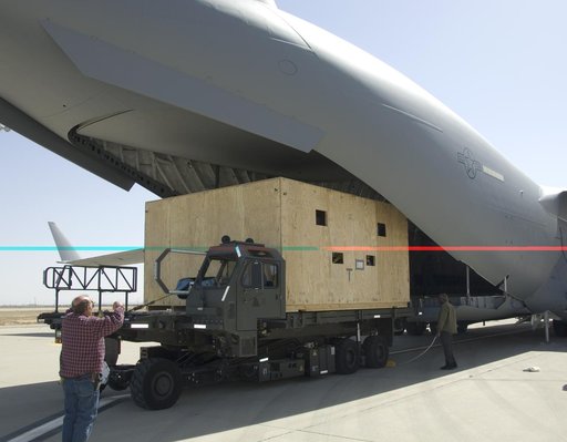 A NASA Technician directs loading of the crated SOFIA primary mirror assembly into a C-17 for shipment to NASA Ames Research Center for finish coating