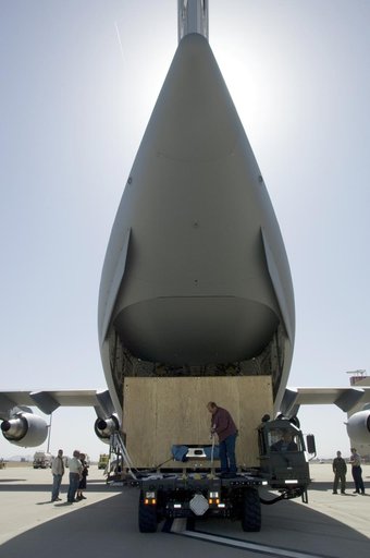 Ground crewmen prepare to load the crated SOFIA primary mirror assembly into an Air Force C-17 for shipment to NASA Ames Research Center for finish coating