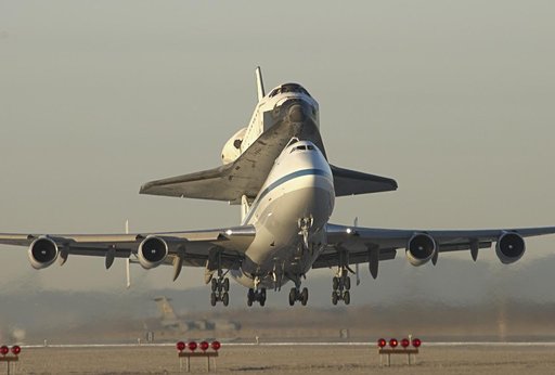Moments after sunrise, the modified 747 carrier aircraft carrying the Endeavour lifts off from Edwards AFB on the first leg of its ferry flight back to KSC