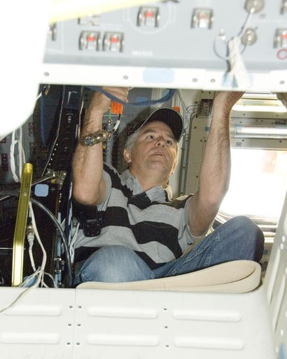 Technician Mark Shimei works inside Space Shuttle Endeavour's flight deck during deservicing operations at NASA Dryden following its landing on Nov. 30, 2008