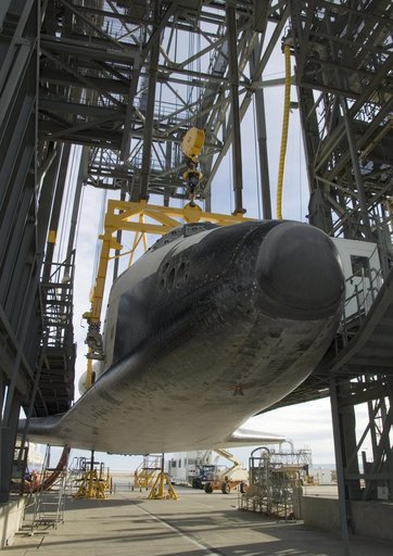 Endeavour is slowly hoisted aloft in the Mate-Demate gantry before being mounted atop its modified 747 carrier aircraft for a ferry flight back to Florida
