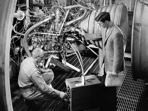 NASA Researchers Examine a Pratt and Whitney RL-10 Rocket Engine