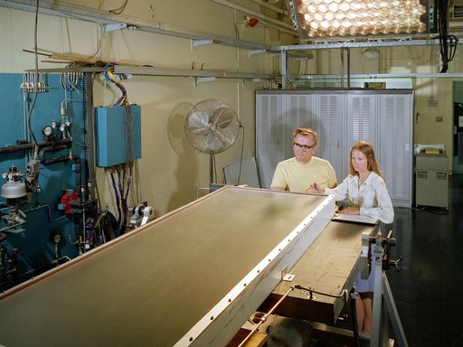Researcher and Mechanic with Solar Collector in Solar Simulator Cell
